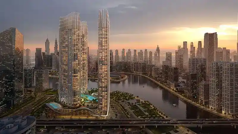 Sunlit luxury towers overlooking a serene water lake and landscaped surroundings