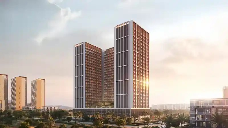 Sunlit luxury tower surrounded by lush greenery and open spaces