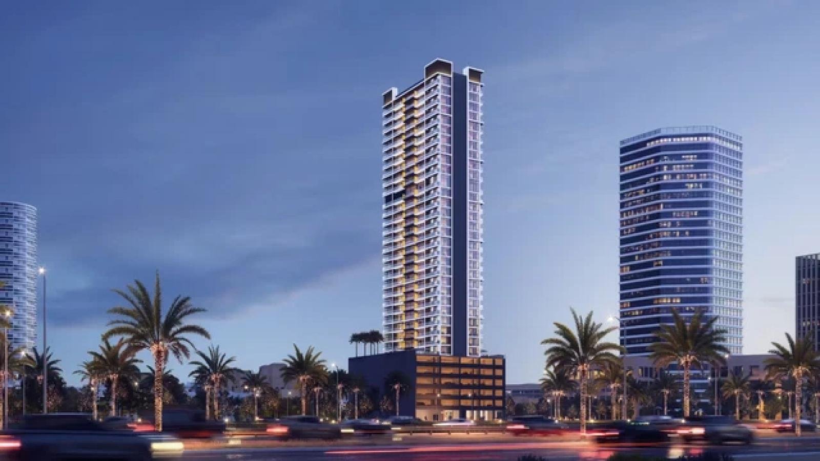 Luxury mirrored towers along a roadside with cars and coconut trees