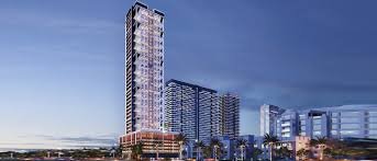 Luxury mirrored towers along a roadside with cars and coconut trees